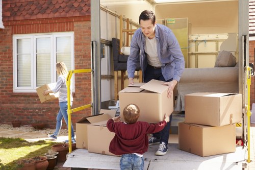 Careful transport of a grand piano through a local residential property